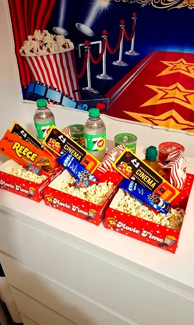 Row of red Movie Time trays filled with popcorn, sweets and drinks