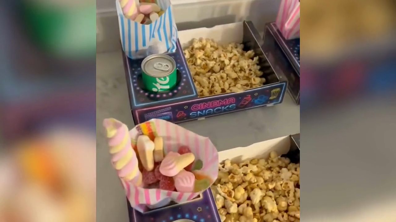 A finished neon MovieJam snack tray held in two hands