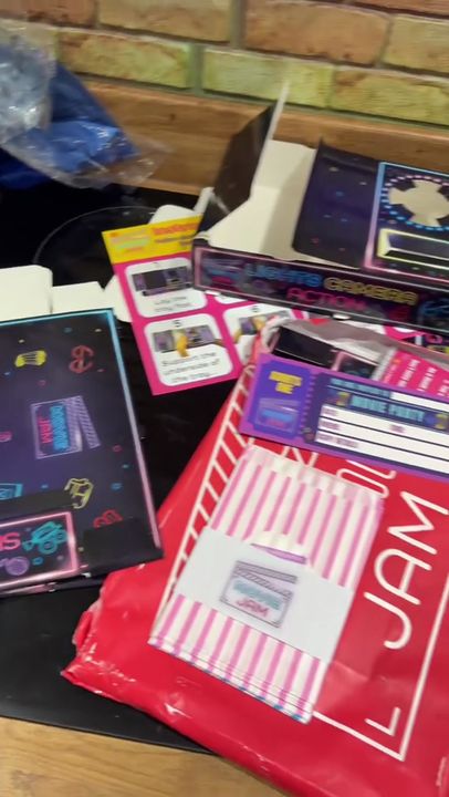 Filled neon trays with popcorn and snacks, then a family watching a film on the sofa