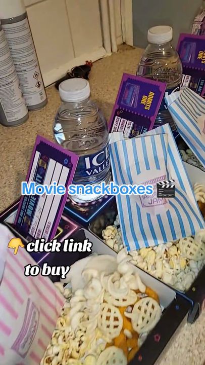 Family fills Movie Jam trays with popcorn and crisps and enjoys them together on the sofa